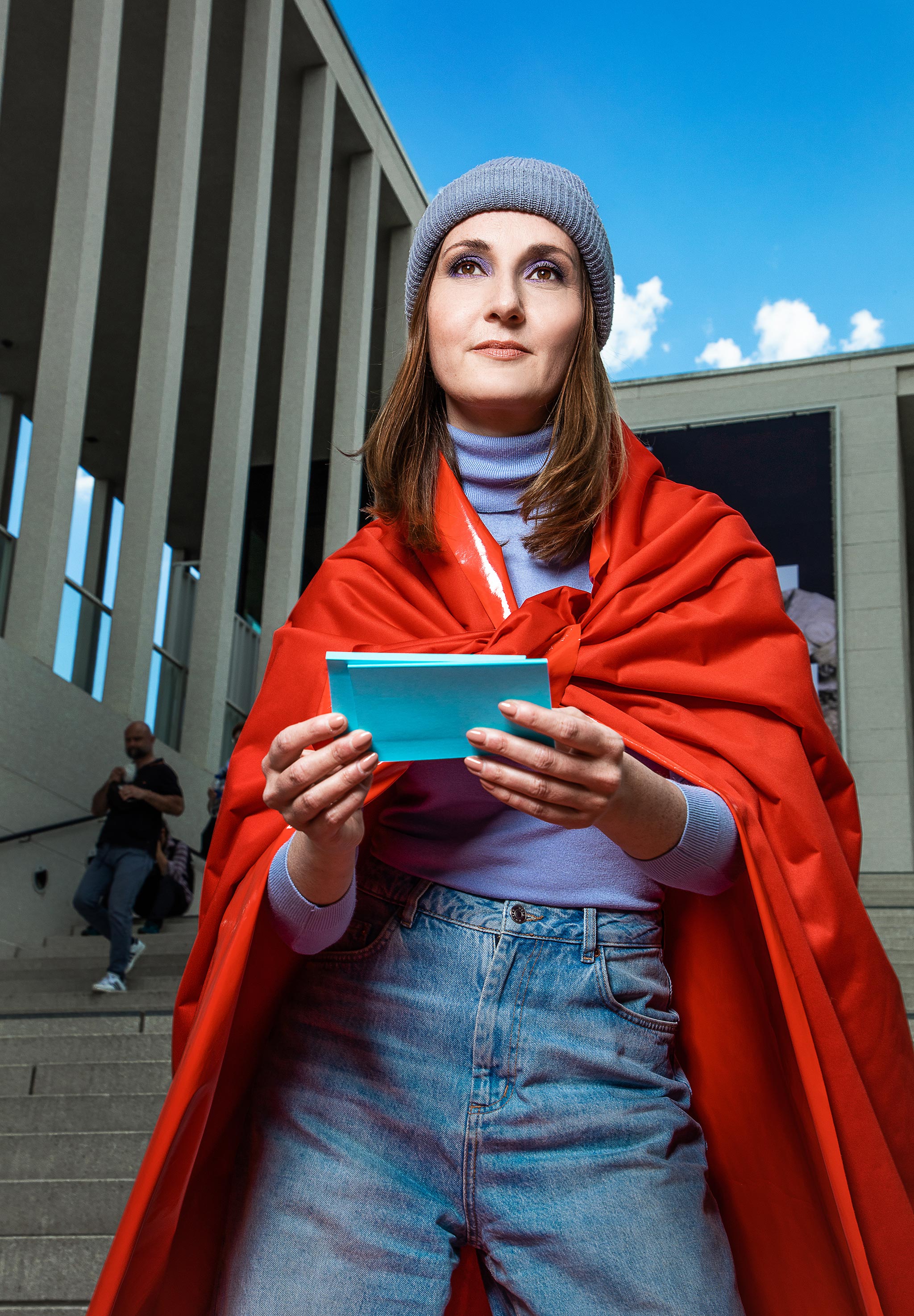 Woman stands on a staircase holding notecards